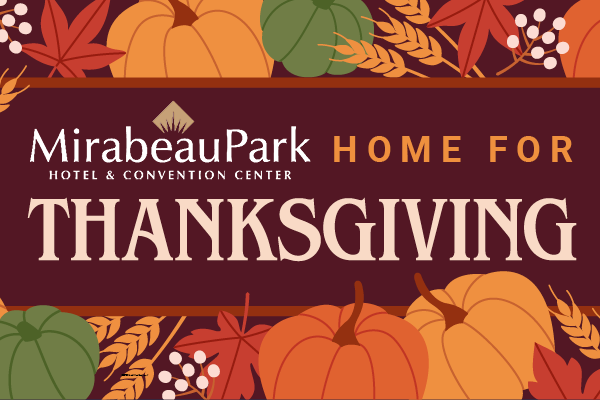 Thanksgiving-themed sign for Mirabeau Park Hotel & Convention Center, surrounded by colorful autumn leaves and pumpkins.